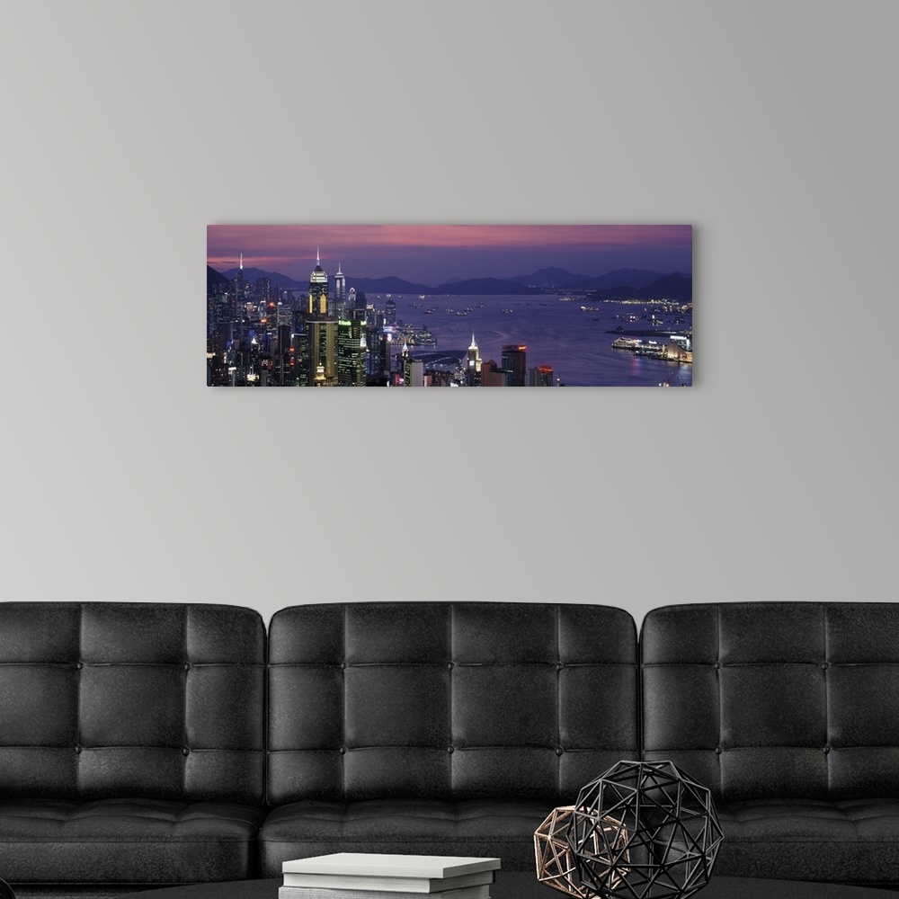 A modern room featuring Panoramic image of twilight and the Hong Kong skyline and water by the city.