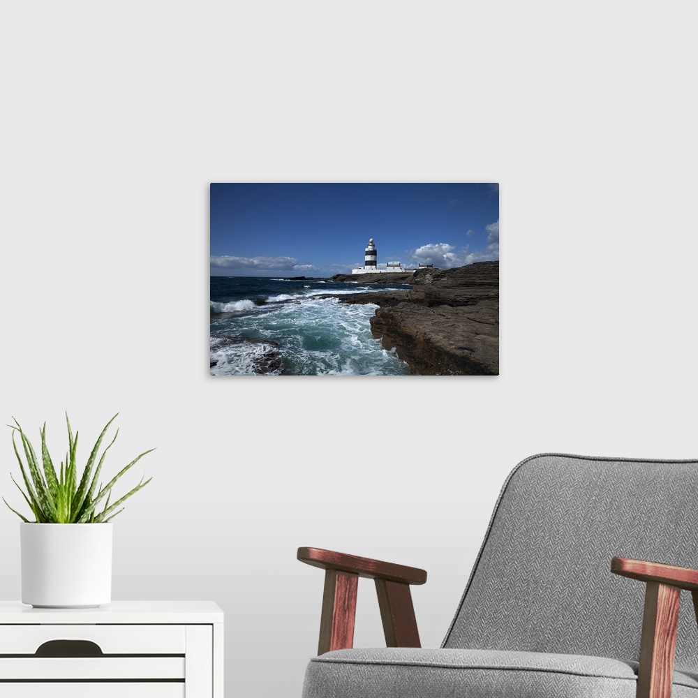 A modern room featuring Landscape photograph on a giant canvas of waves crashing into the rocky shoreline in County Wexfo...