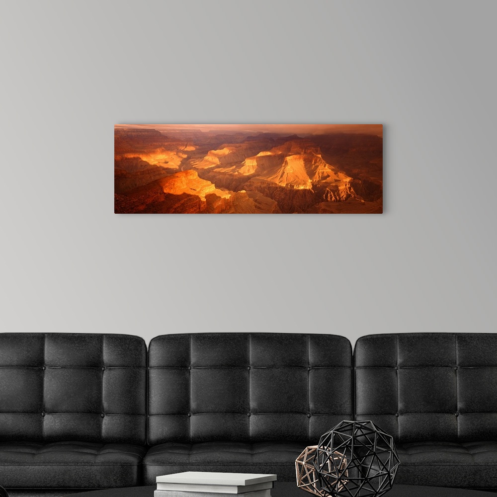 A modern room featuring Giant, horizontal, aerial photograph of Hopi Point Canyon in the golden sunlight, at the Grand Ca...