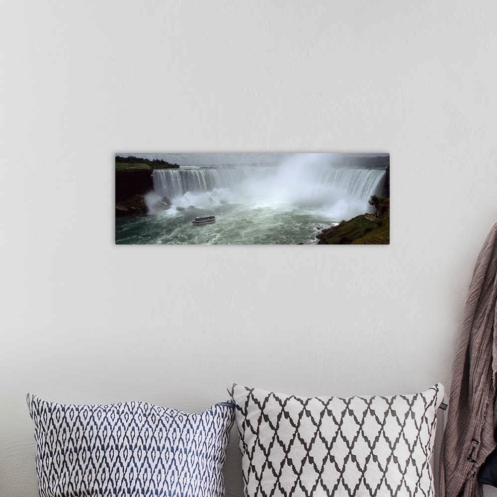 A bohemian room featuring Panoramic photograph of a section of the Niagara waterfall on the border of New York State and Ca...