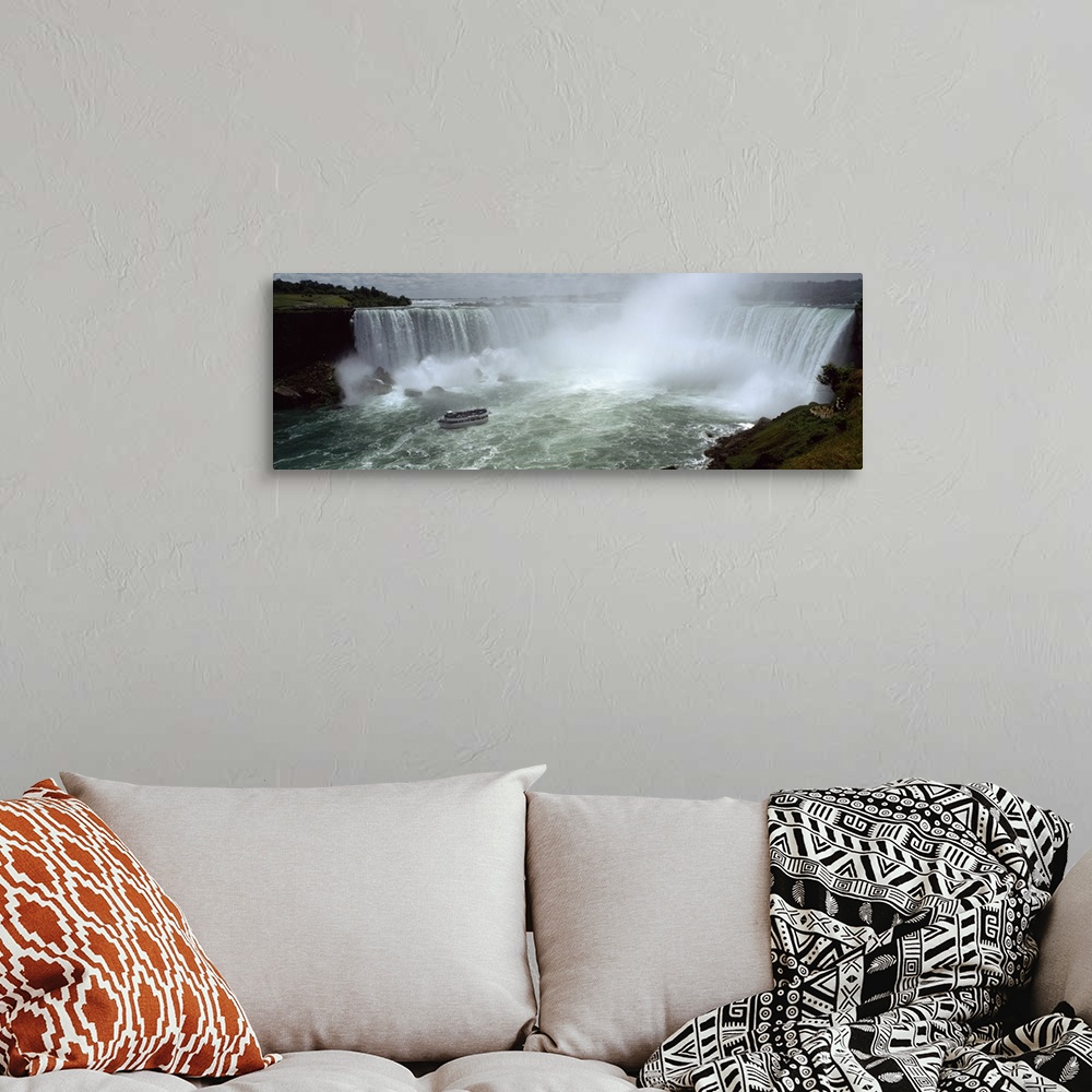 A bohemian room featuring Panoramic photograph of a section of the Niagara waterfall on the border of New York State and Ca...