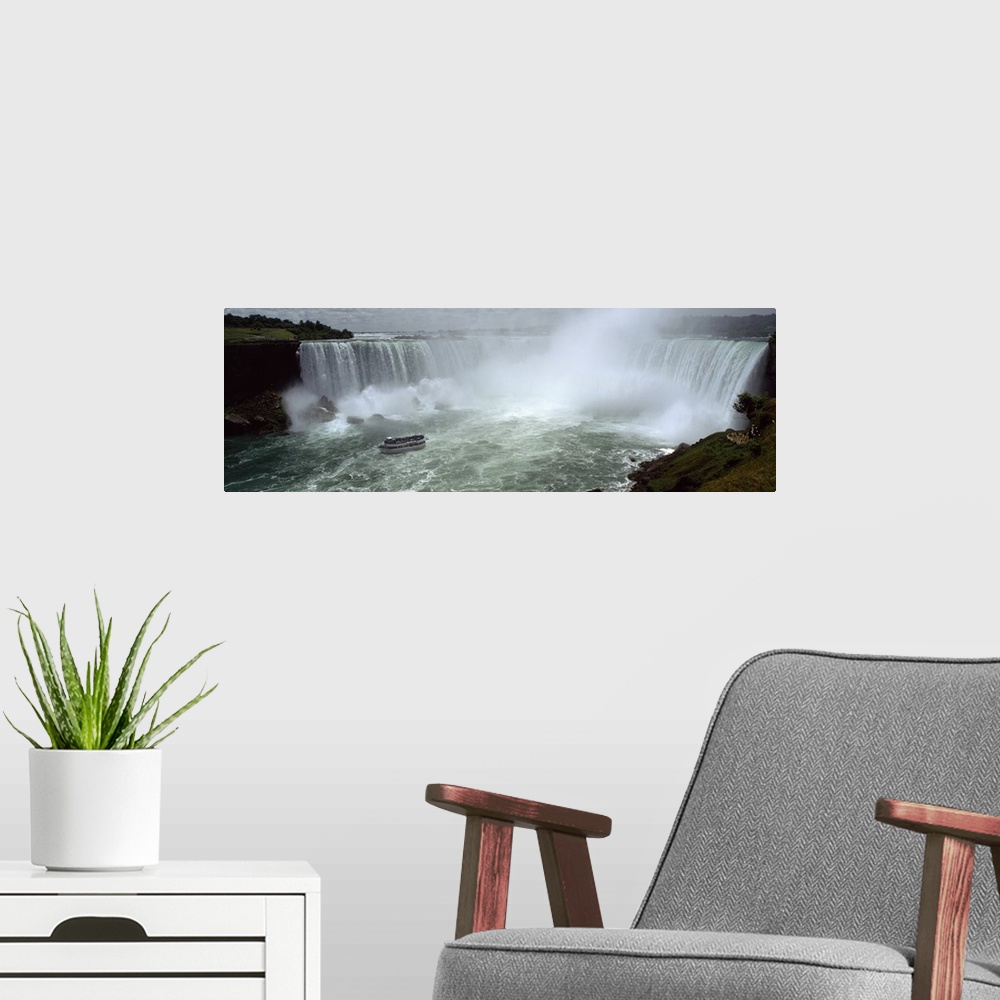 A modern room featuring Panoramic photograph of a section of the Niagara waterfall on the border of New York State and Ca...