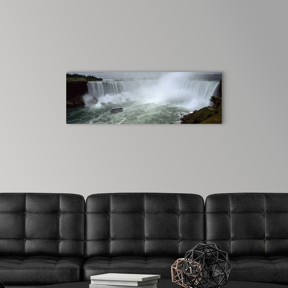 A modern room featuring Panoramic photograph of a section of the Niagara waterfall on the border of New York State and Ca...