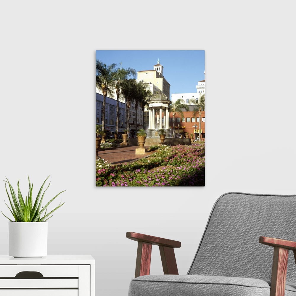 A modern room featuring San Diego, California's Horton Plaza with flowers and palm trees.