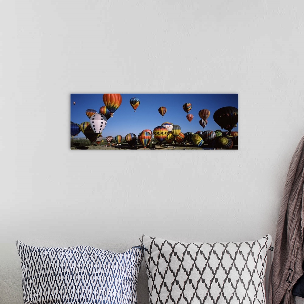 A bohemian room featuring Panoramic photo of dozens of colorful hot air balloons taking flight at the International Balloon...