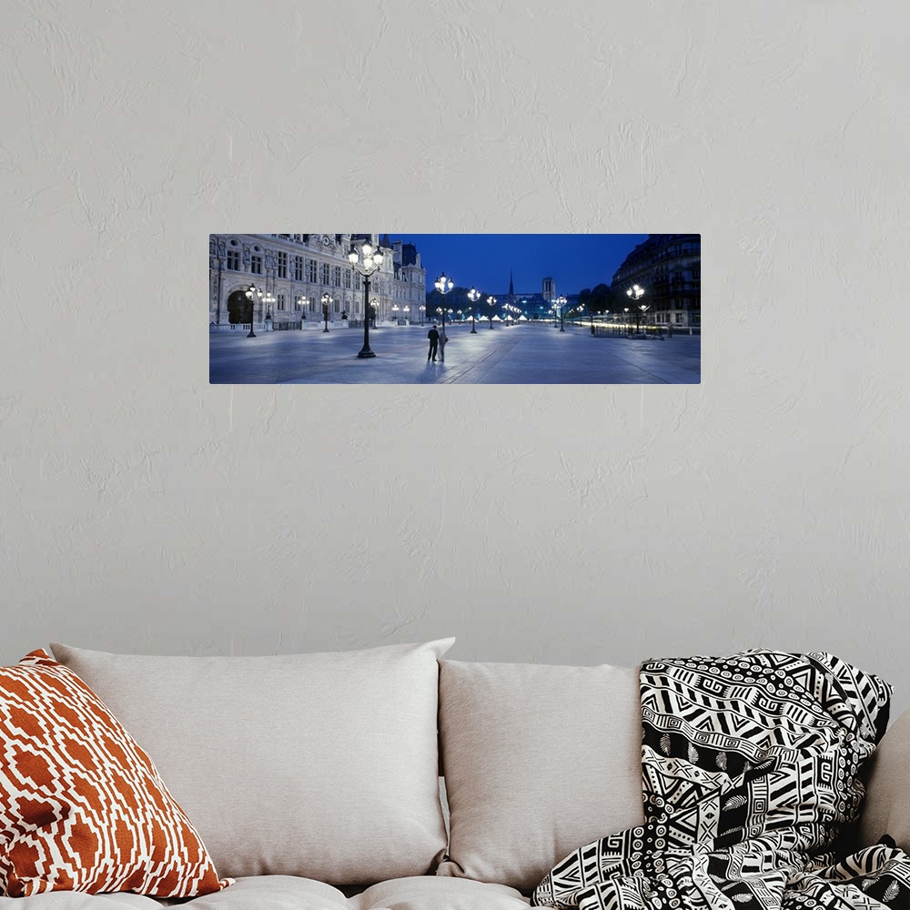 A bohemian room featuring Panoramic image of a street outside the Hotel de Ville lit up at night in Paris, France.