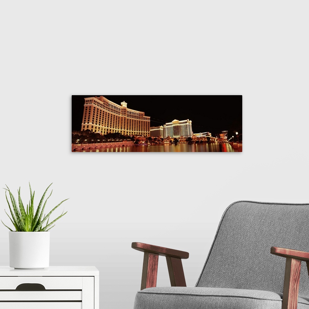 A modern room featuring Panoramic photograph of iconic hotel and gambling establishment in ""Sin City.""  The buildings a...