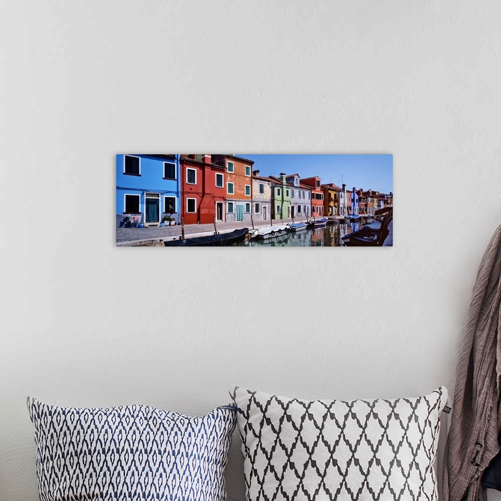 A bohemian room featuring Panoramic photograph of colorful houses lined up next to each other on a lagoon with boats tied u...