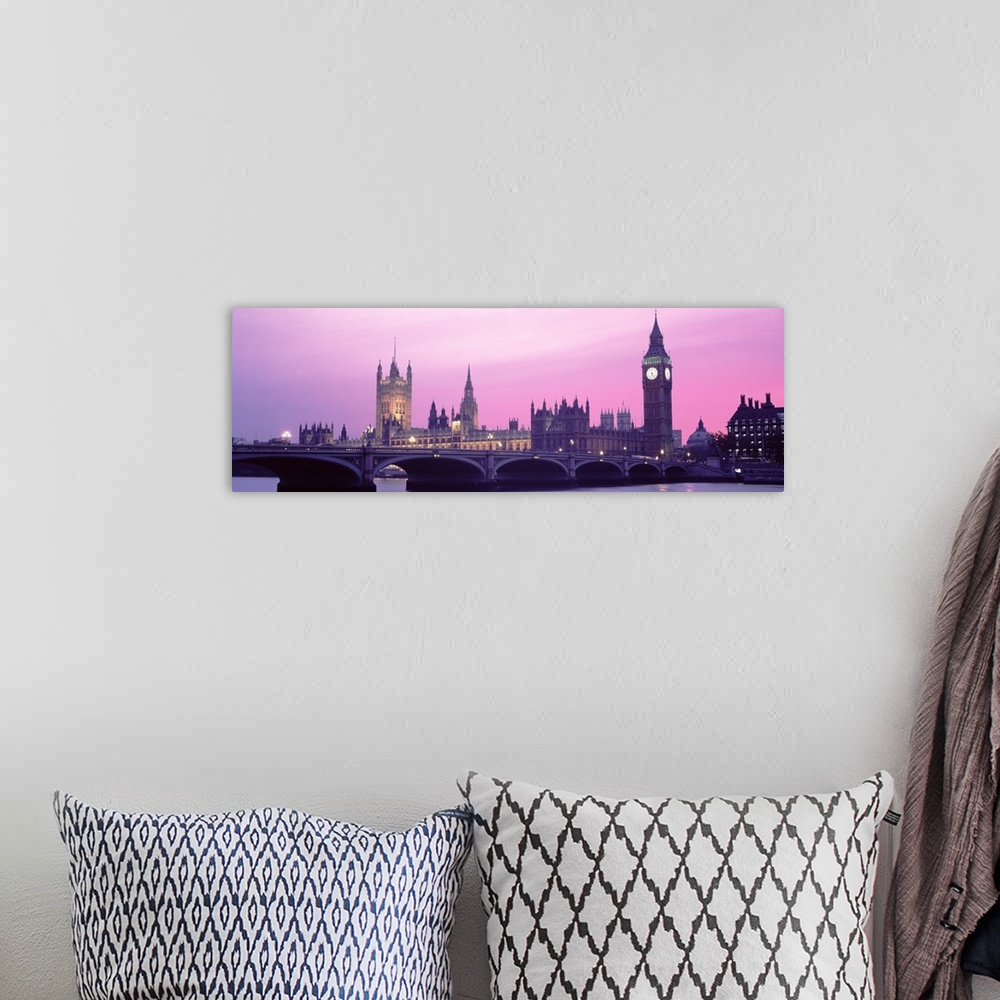 A bohemian room featuring London Skyline in the evening. Thames river in foreground with Big Ben, Halls of Parliament. The ...