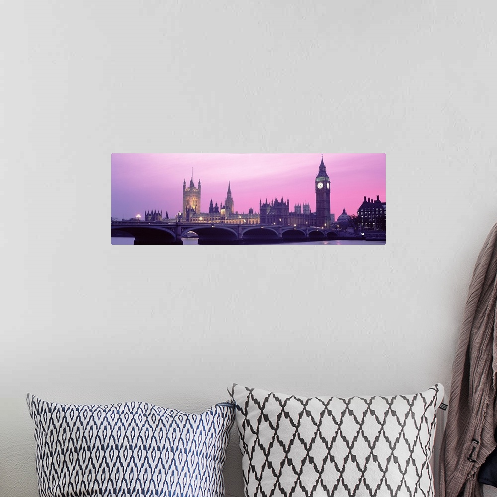 A bohemian room featuring London Skyline in the evening. Thames river in foreground with Big Ben, Halls of Parliament. The ...