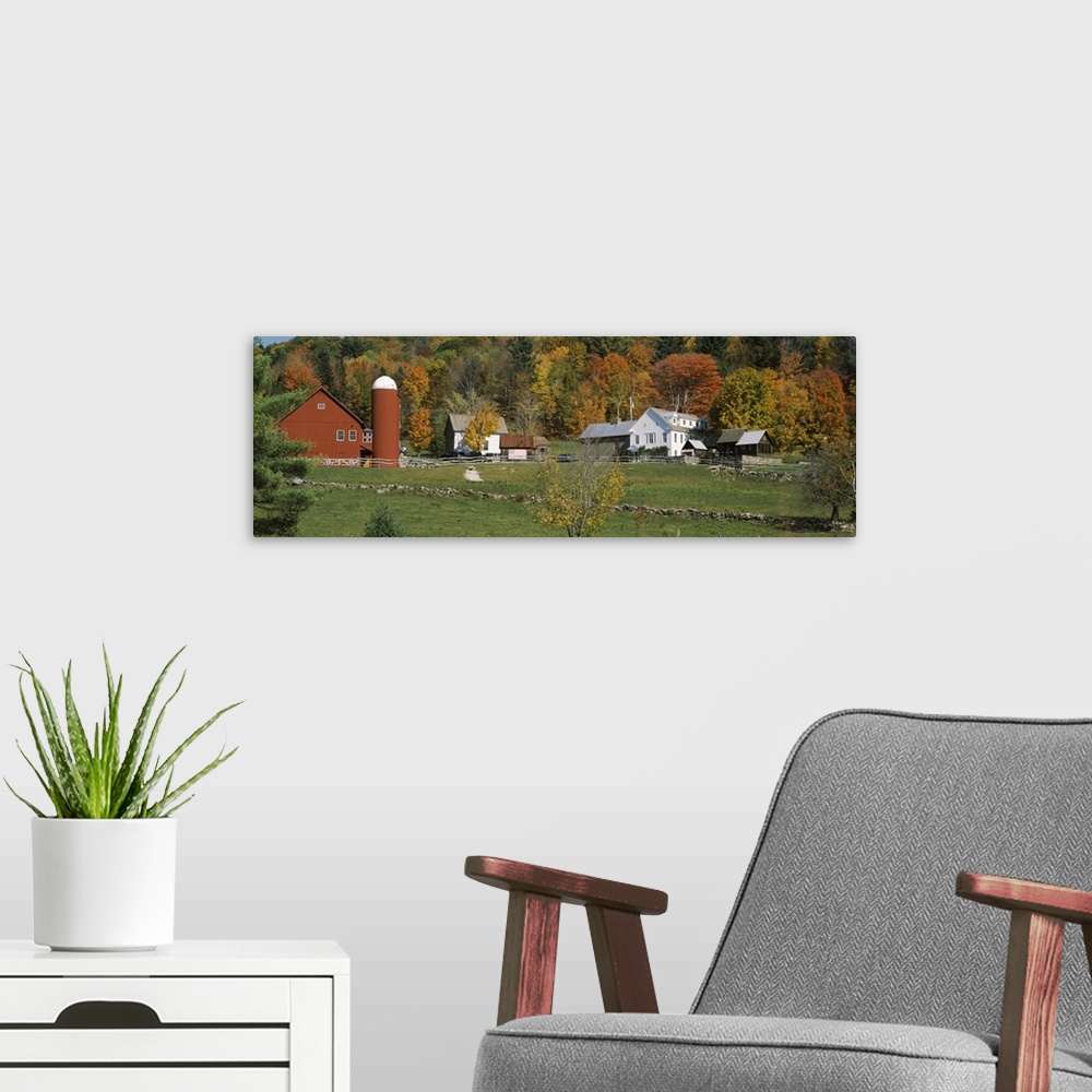 A modern room featuring Red barn and house in VT..Red barn, house and rock walls at bast of hill with Fall color trees at...