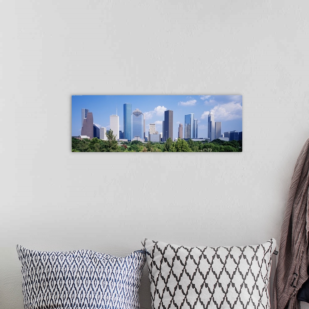 A bohemian room featuring Panoramic photo of the Houston cityscape against a blue sky.