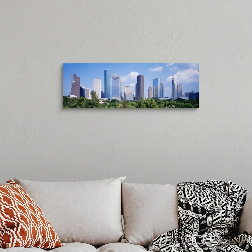 A bohemian room featuring Panoramic photo of the Houston cityscape against a blue sky.