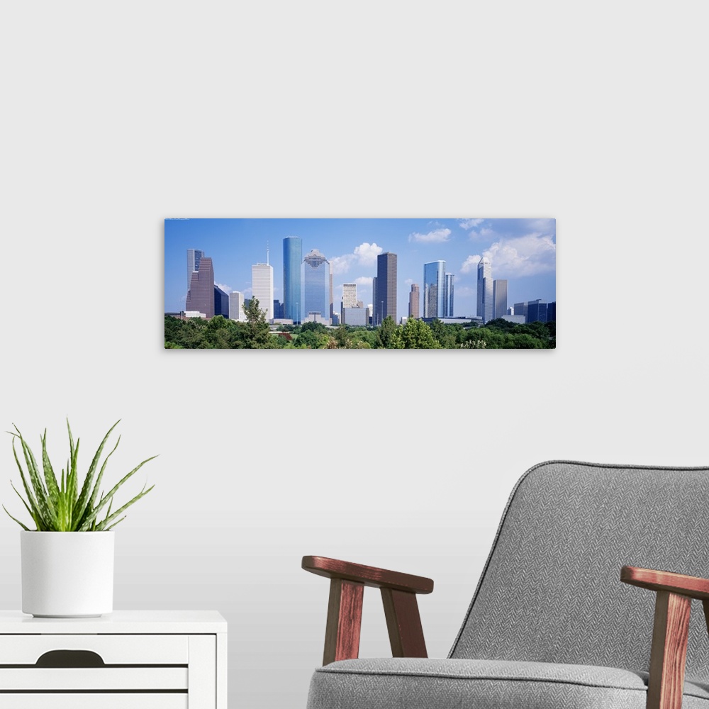 A modern room featuring Panoramic photo of the Houston cityscape against a blue sky.