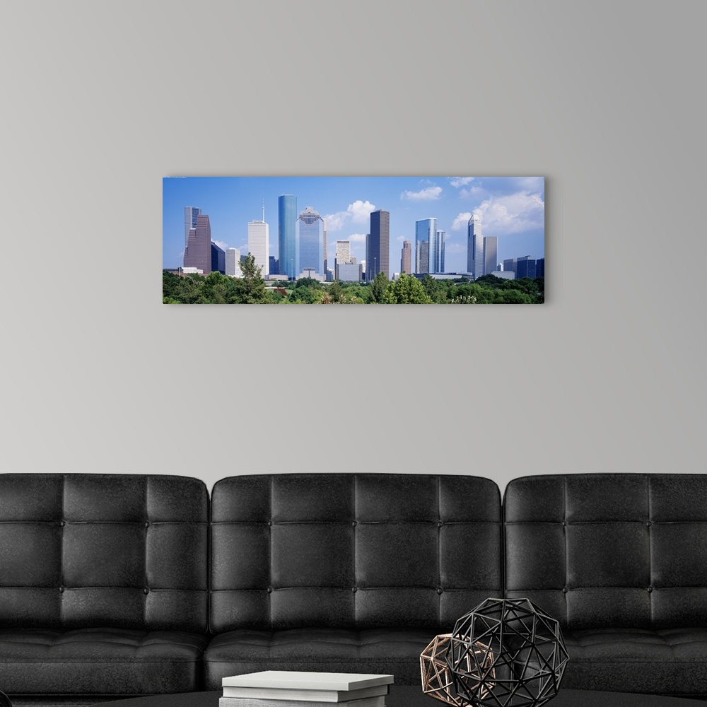A modern room featuring Panoramic photo of the Houston cityscape against a blue sky.