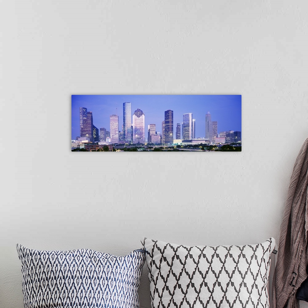 A bohemian room featuring Panoramic photograph of skyline lit up at dusk.
