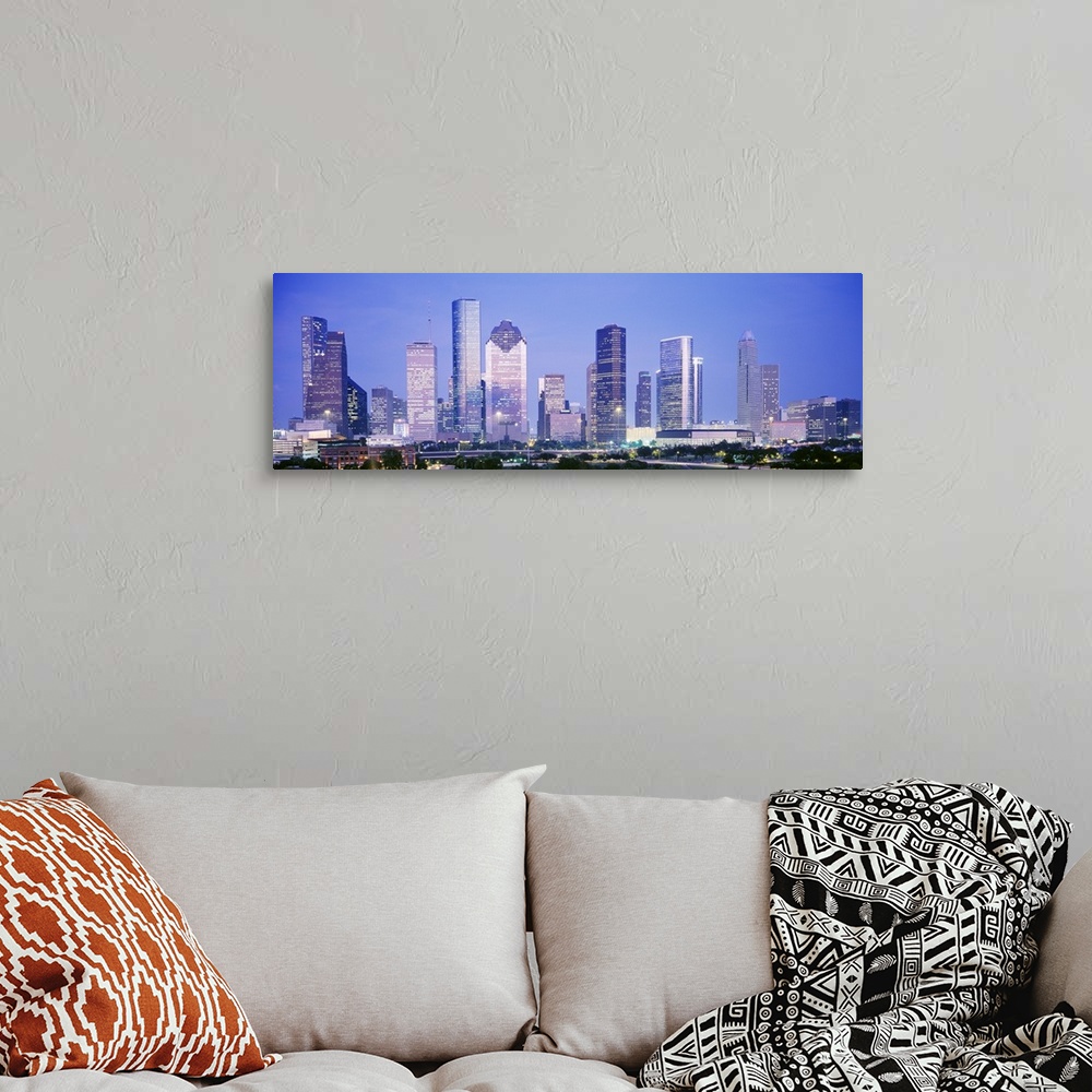 A bohemian room featuring Panoramic photograph of skyline lit up at dusk.