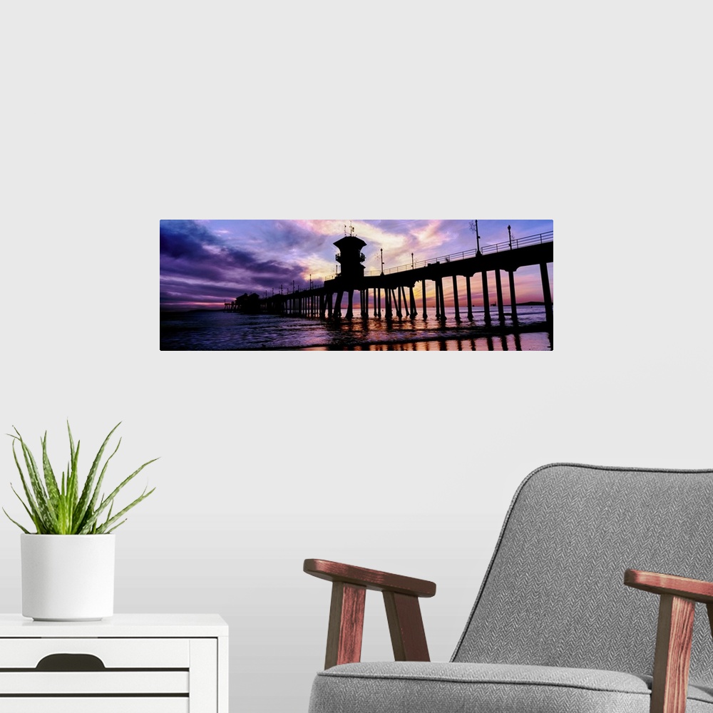 A modern room featuring Huntington Beach Pier at sunset, Huntington Beach, California, USA.