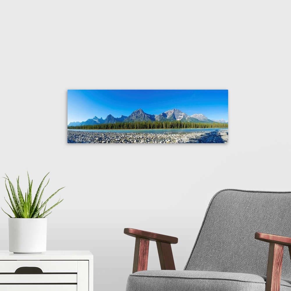 A modern room featuring Stones in Athabasca River with mountains in the background, Icefields Parkway, Jasper National Pa...