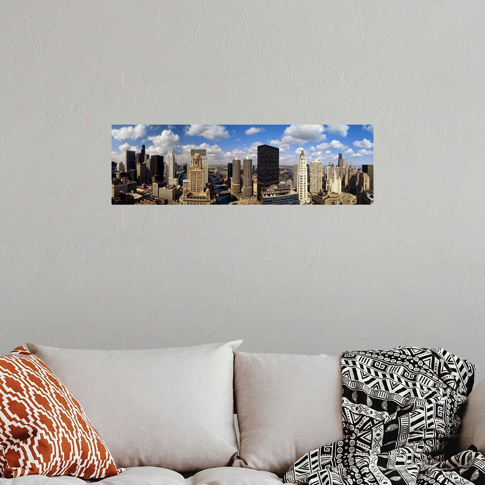 A bohemian room featuring Panoramic of tall buildings in Chicago with white puffy clouds in the sky.