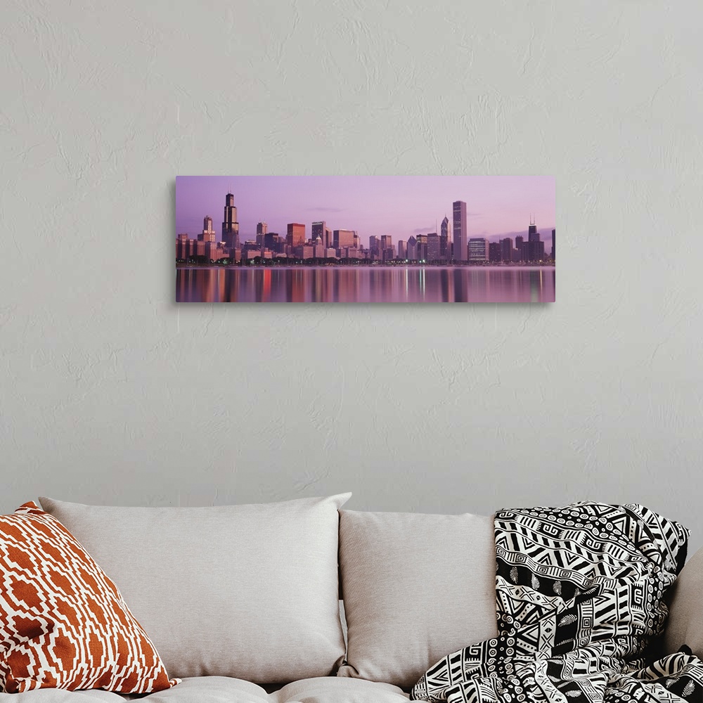 A bohemian room featuring Panoramic photograph of skyline and waterfront lit up at dusk.  The buildings are reflected in th...