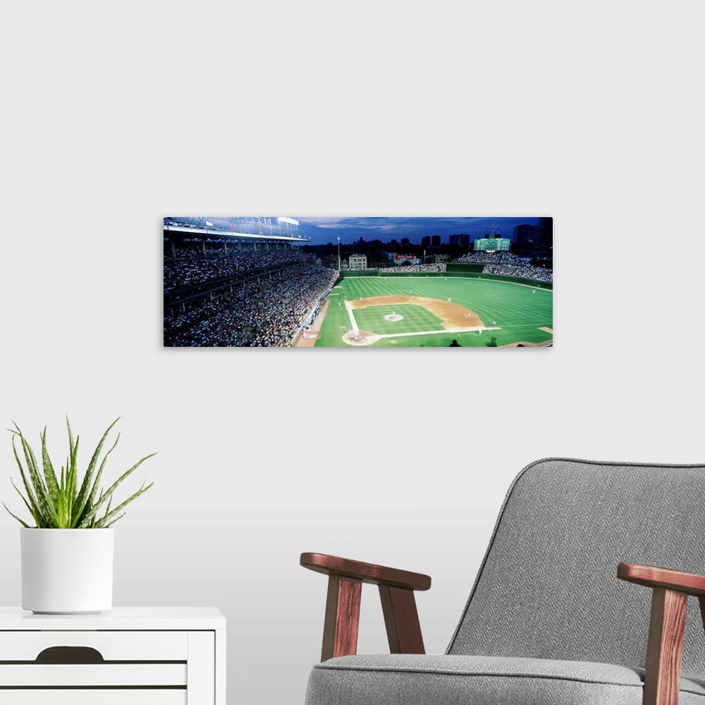 A modern room featuring Panoramic photograph taken from the top section behind home plate overlooking historic Wrigley Fi...