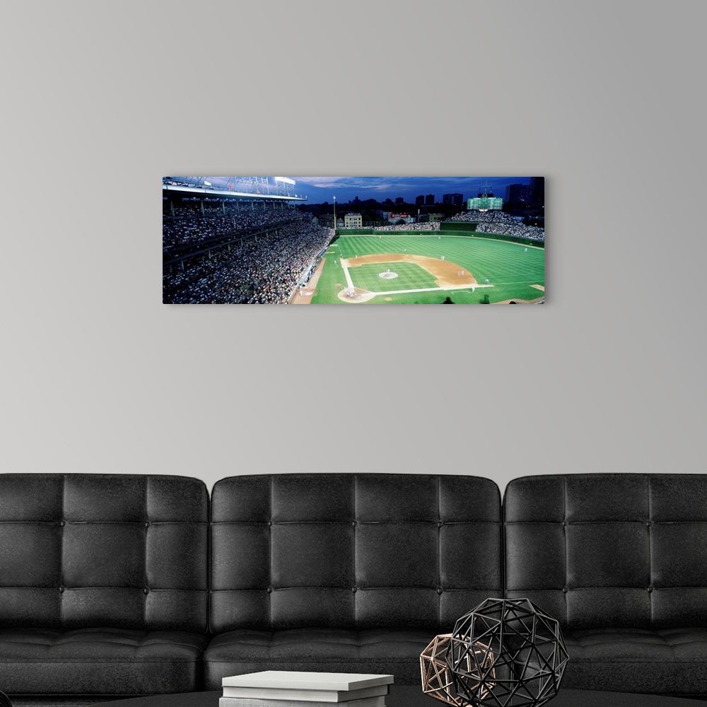 A modern room featuring Panoramic photograph taken from the top section behind home plate overlooking historic Wrigley Fi...