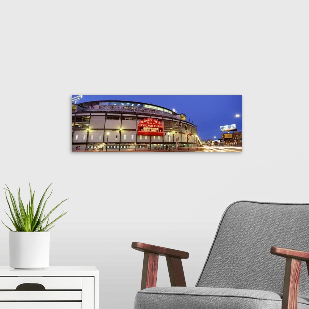 A modern room featuring Panoramic photograph displays a nighttime view of the famous marquee sitting outside Wrigley Fiel...