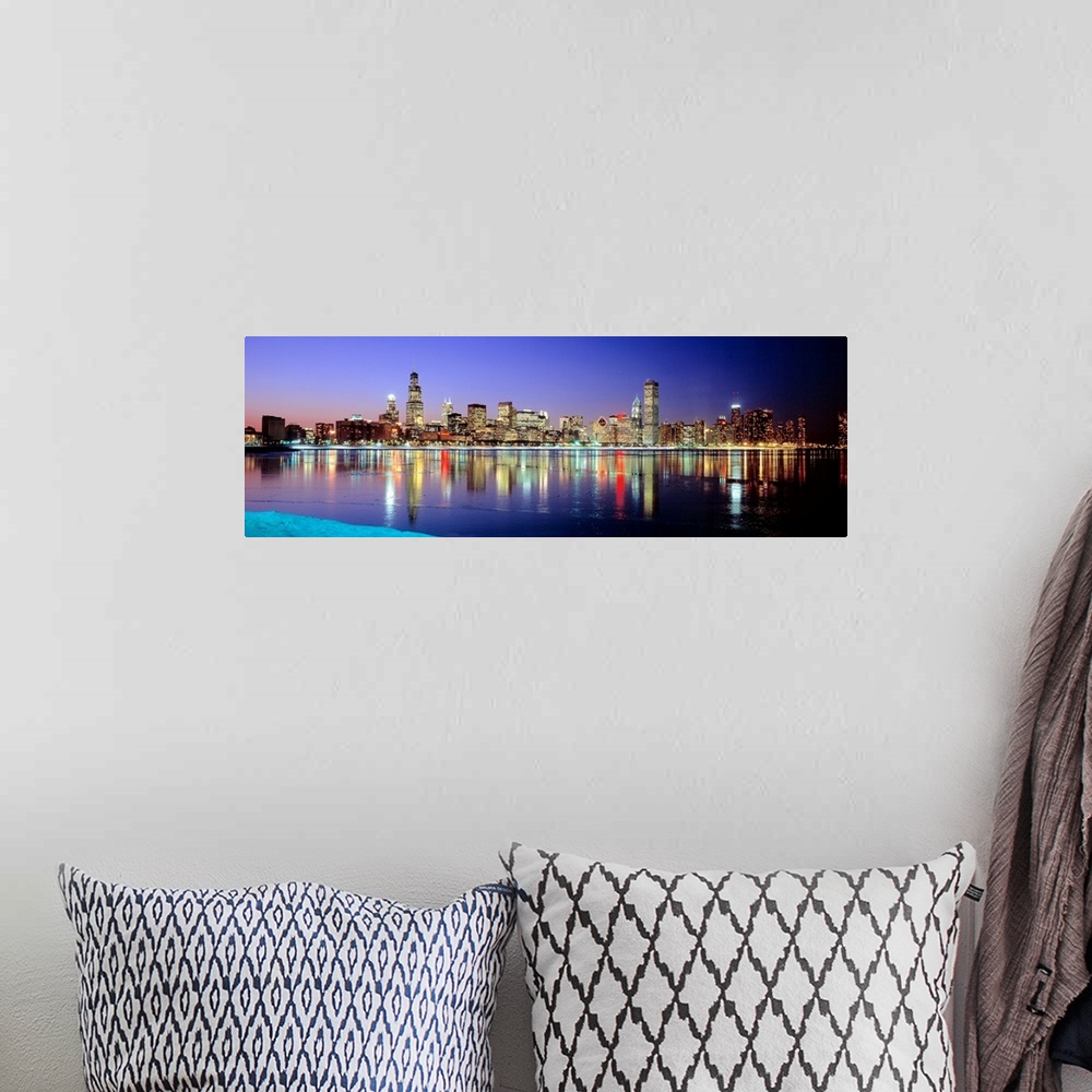 A bohemian room featuring Panoramic photographic canvas of a cityscape illuminated with colored lights reflected perfectly ...