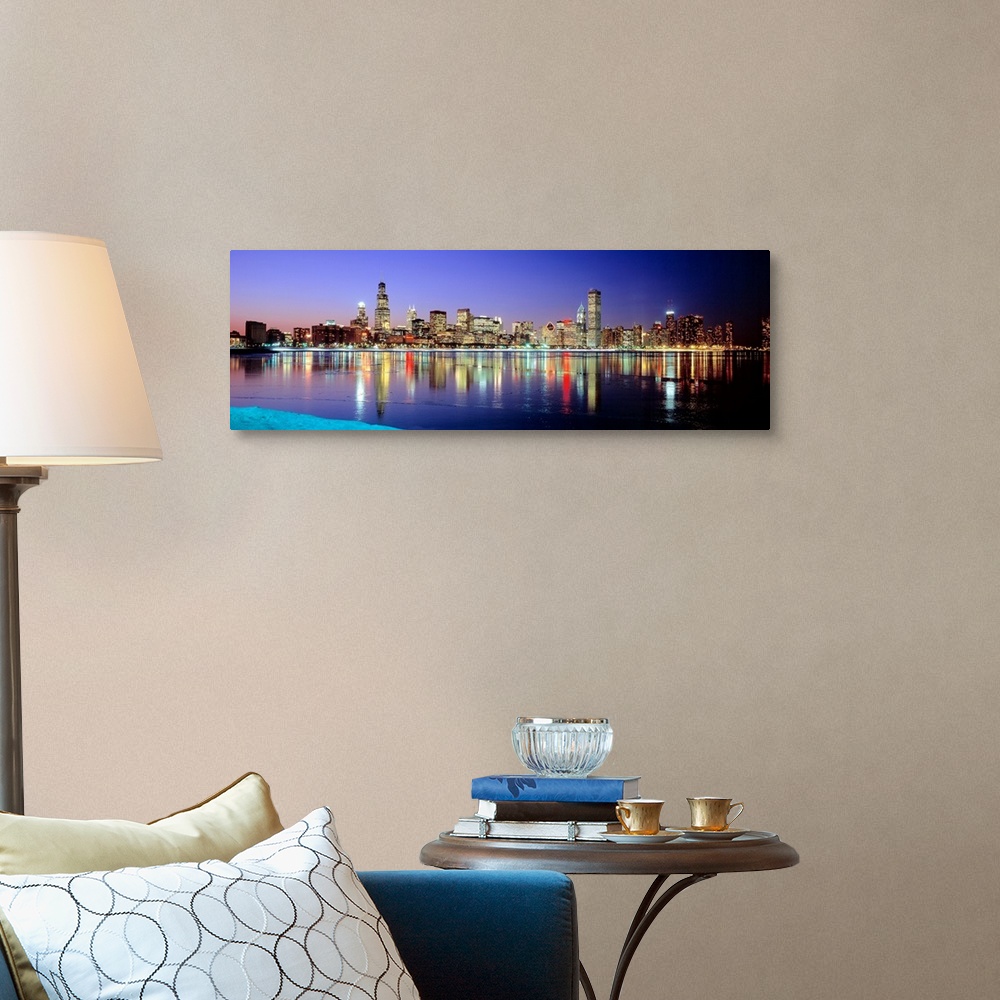 A traditional room featuring Panoramic photographic canvas of a cityscape illuminated with colored lights reflected perfectly ...