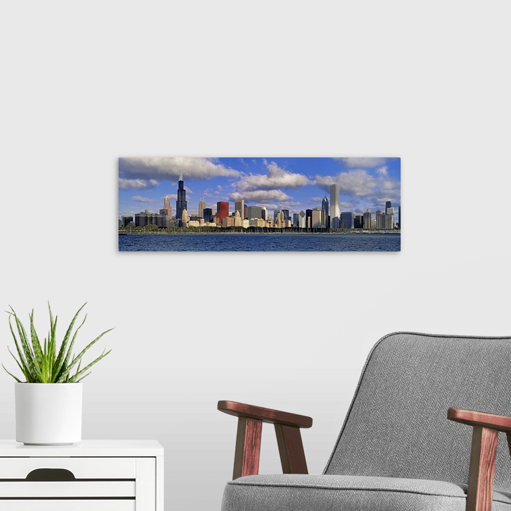 A modern room featuring Long panoramic photo print of the Chicago skyline during a bright day by the waterfront.