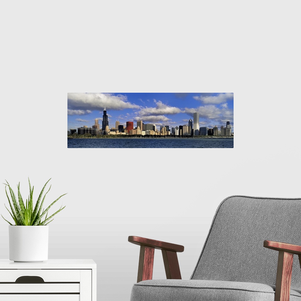A modern room featuring Large panoramic photograph of downtown Chicago, Illinois (IL) on a suny day with large clouds in ...