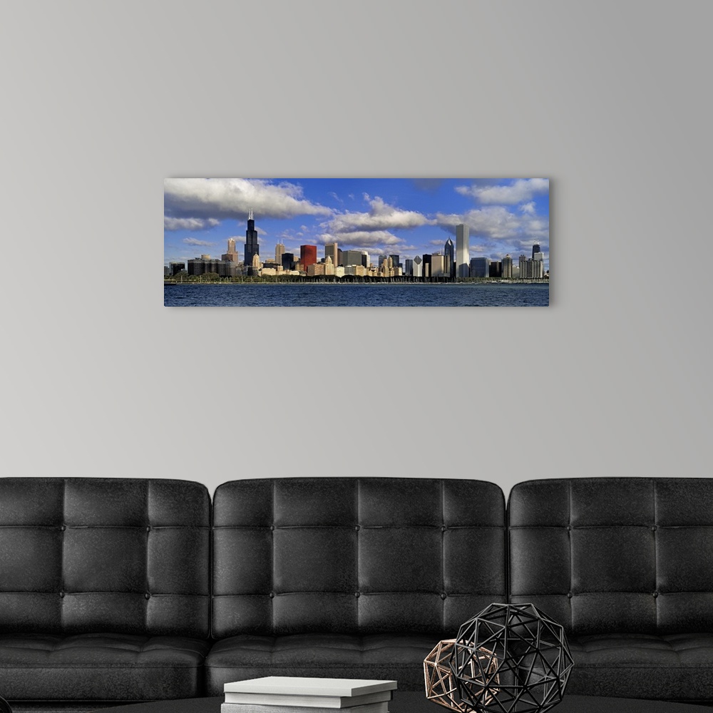 A modern room featuring Large panoramic photograph of downtown Chicago, Illinois (IL) on a suny day with large clouds in ...