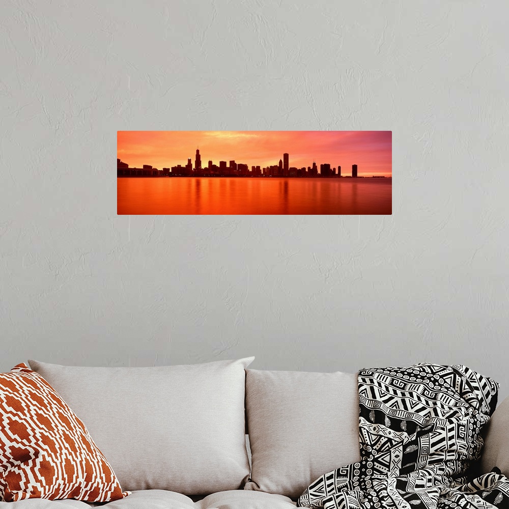 A bohemian room featuring Panoramic photograph of skyline silhouette and waterfront at dusk.