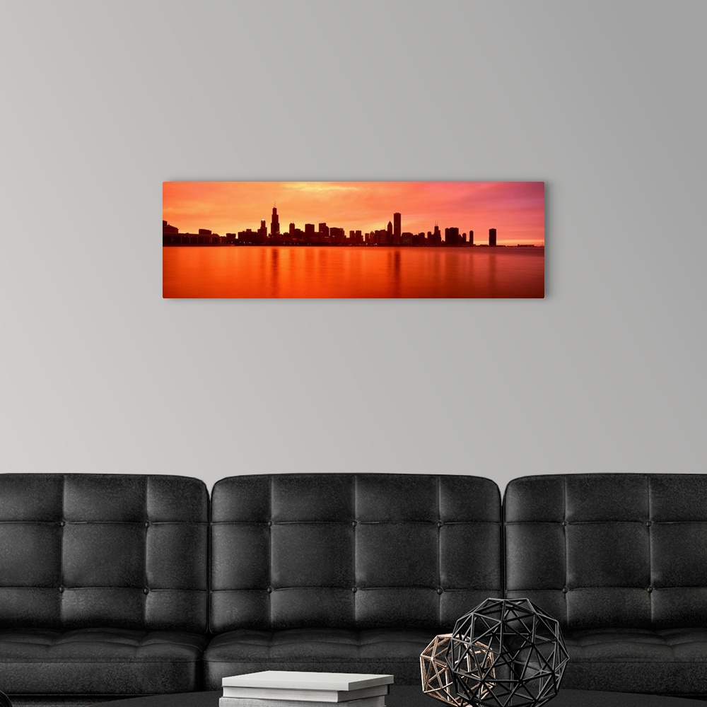 A modern room featuring Panoramic photograph of skyline silhouette and waterfront at dusk.