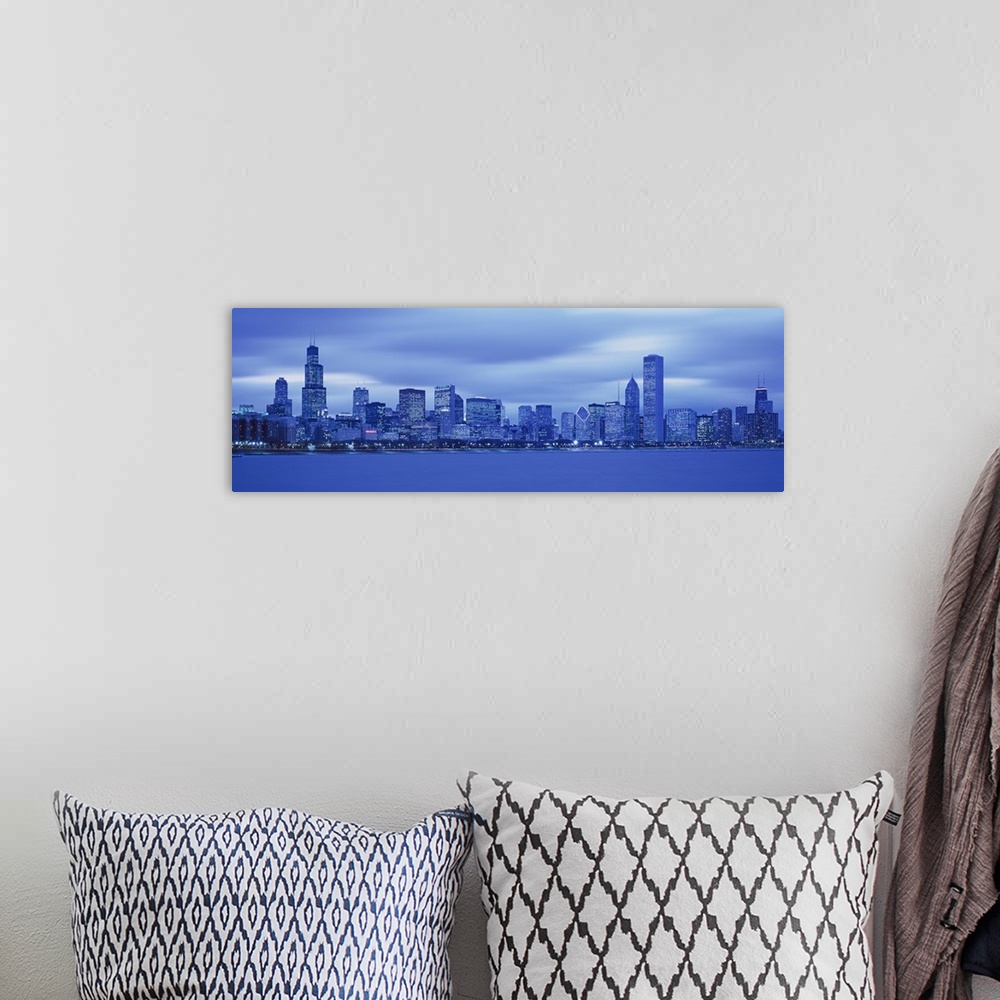 A bohemian room featuring The Chicago skyline is  photographed in panoramic view with a cool tone over the entire picture.