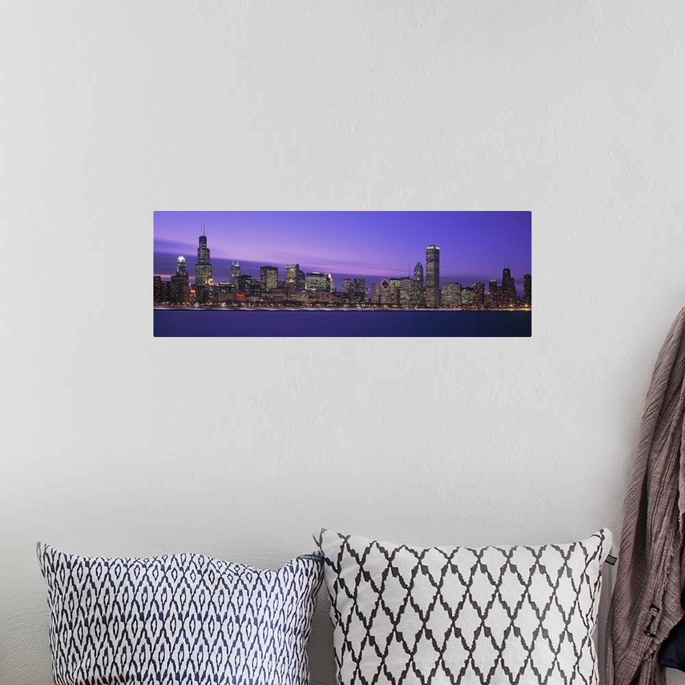 A bohemian room featuring Oversized, horizontal, panoramic photograph of lit skyscrapers of the Chicago skyline at night.