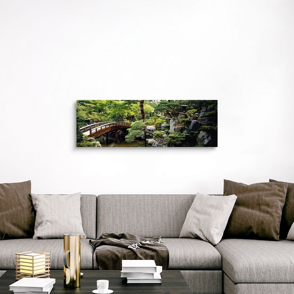 A traditional room featuring Panoramic photo on canvas of a bridge leading over a river with a garden on the right.