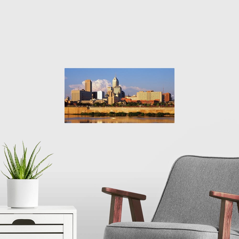 A modern room featuring Photograph of the Indianapolis, Indiana city skyline from the water on a sunny day.