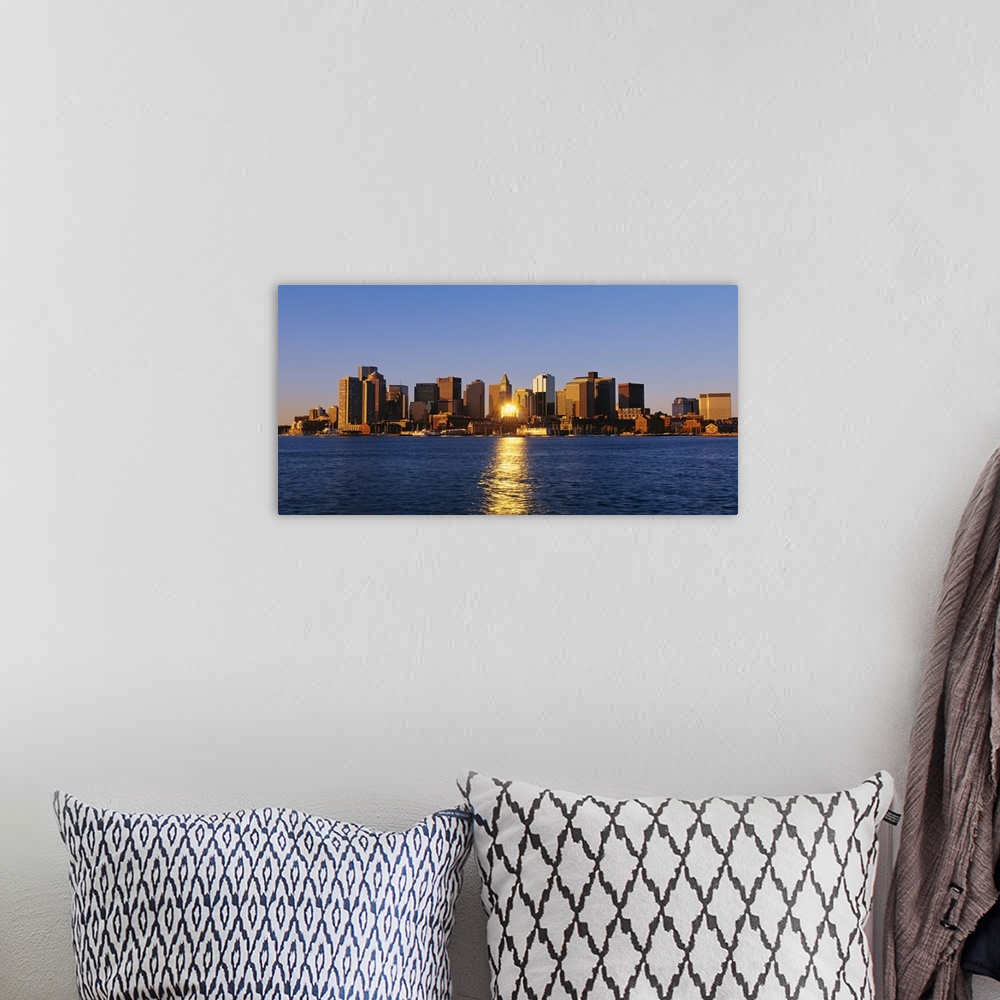 A bohemian room featuring Giant photograph displays the distant skyline of a busy city in the Northeastern United States.  ...