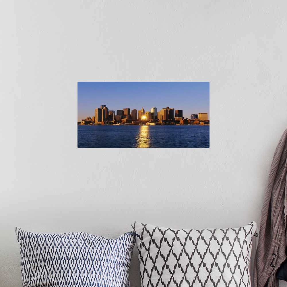 A bohemian room featuring Giant photograph displays the distant skyline of a busy city in the Northeastern United States.  ...