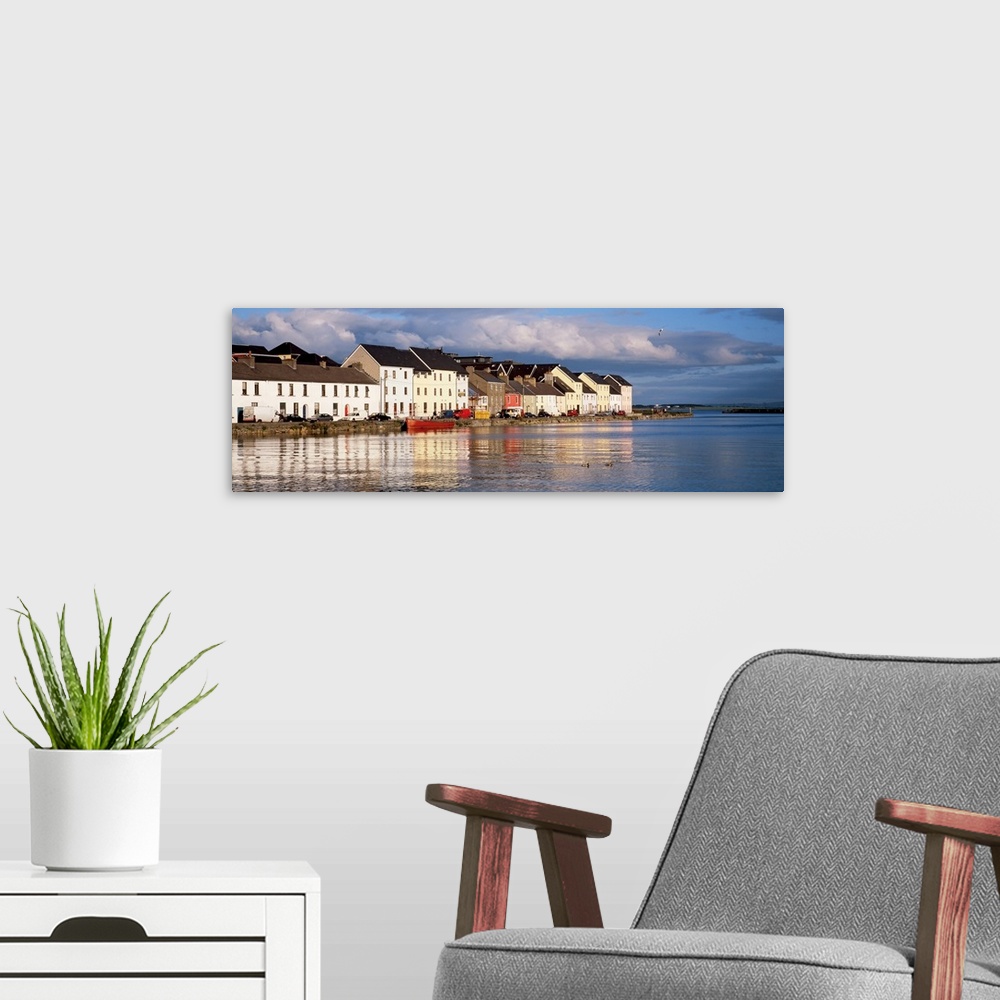 A modern room featuring Long horizontal photo print of colorful Irish buildings and houses along the waterfront.