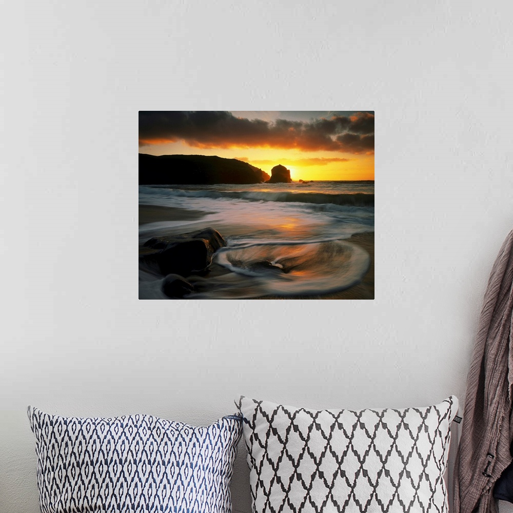 A bohemian room featuring Beautiful time lapsed photography wall art of waves on the beach at sunset.