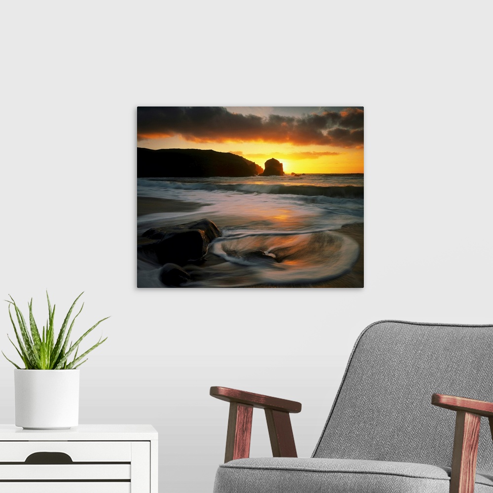 A modern room featuring Beautiful time lapsed photography wall art of waves on the beach at sunset.