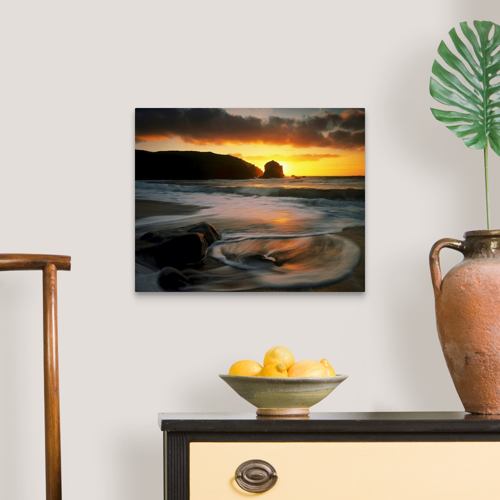 A traditional room featuring Beautiful time lapsed photography wall art of waves on the beach at sunset.