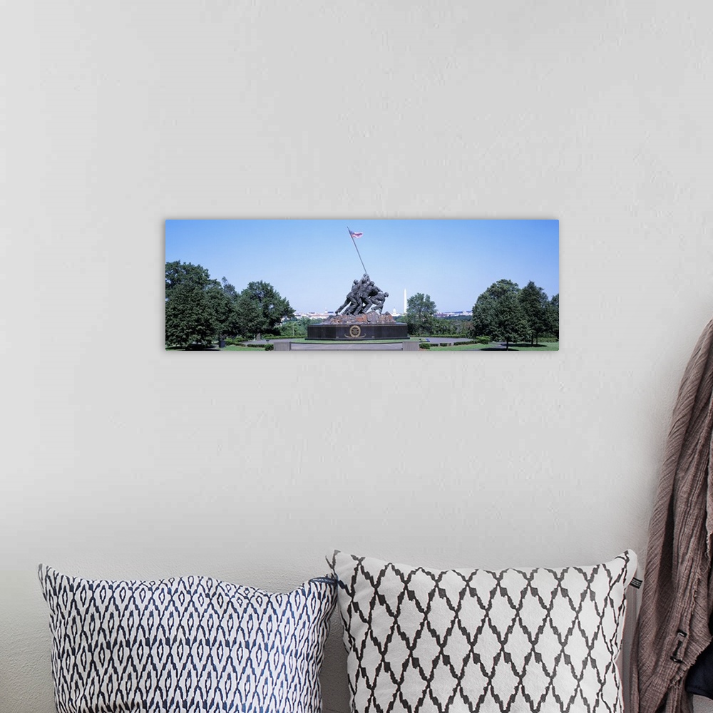 A bohemian room featuring Panoramic photograph of memorial featuring bronze soldiers lifting an American flag.