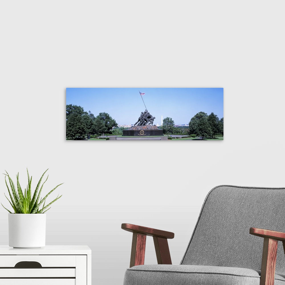 A modern room featuring Panoramic photograph of memorial featuring bronze soldiers lifting an American flag.