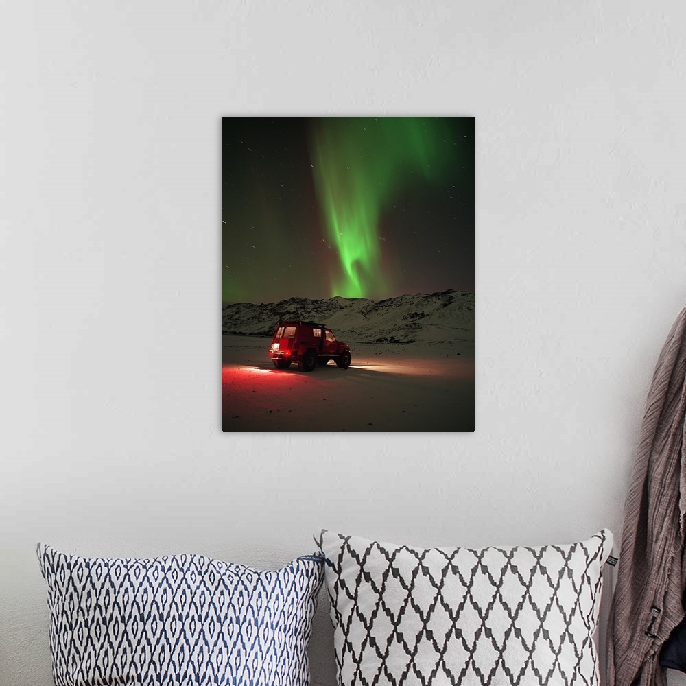 A bohemian room featuring Jeep in a snow covered field with Aurora Borealis in the sky