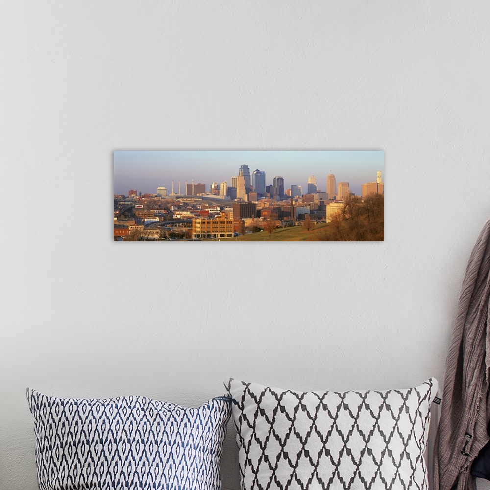 A bohemian room featuring Big, landscape photograph taken from a hillside, of the Kansas City skyline, including the Power ...