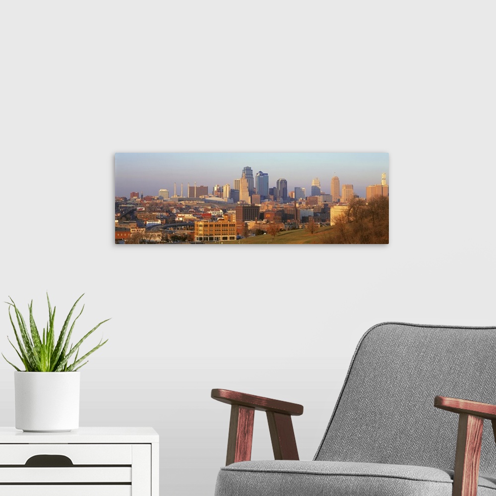 A modern room featuring Big, landscape photograph taken from a hillside, of the Kansas City skyline, including the Power ...